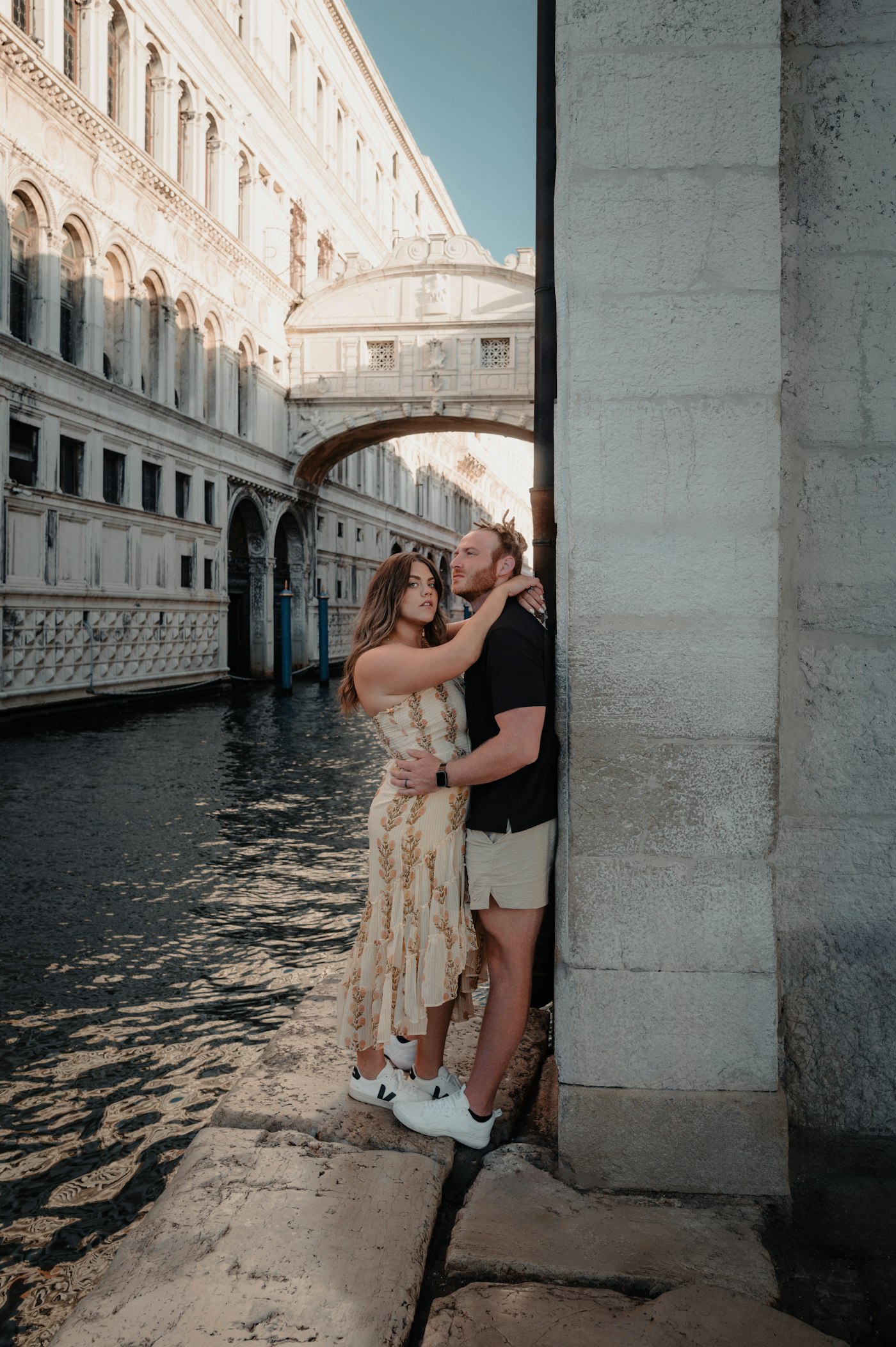 Couple embracing beside a Venice canal
